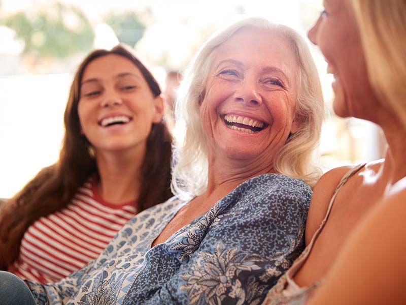 Three generations of a family smiling together