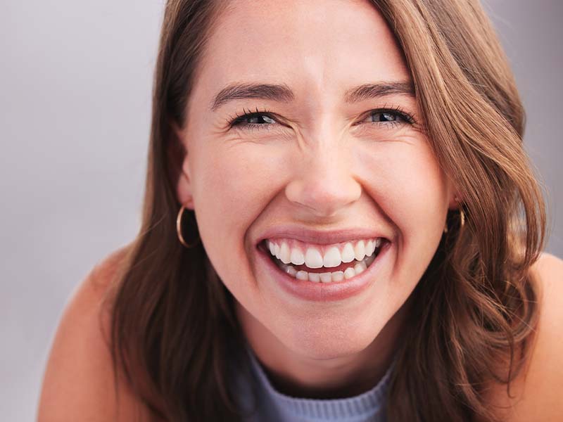 Young woman laughing and showing her smile