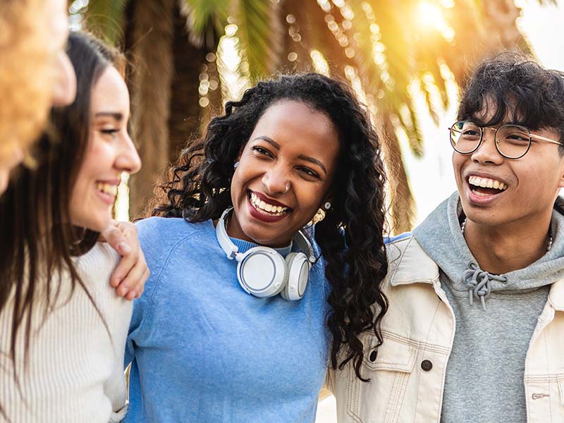 Group of young adults smiling together in an urban setting