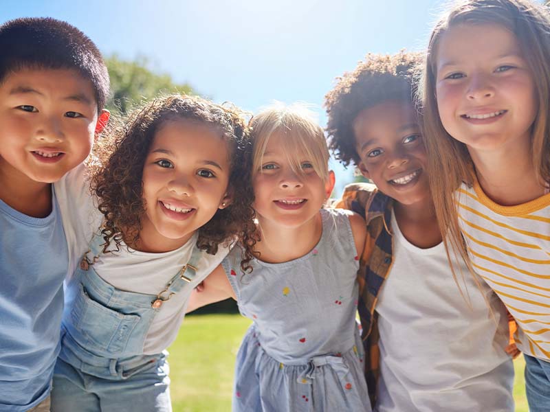 Group of children smiling together outdoors