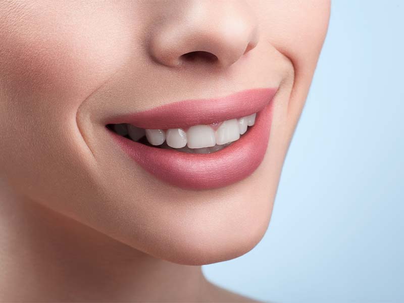 Close-up cropped view of a woman smiling