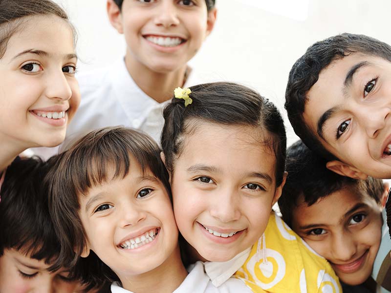 Group of children smiling together indoors